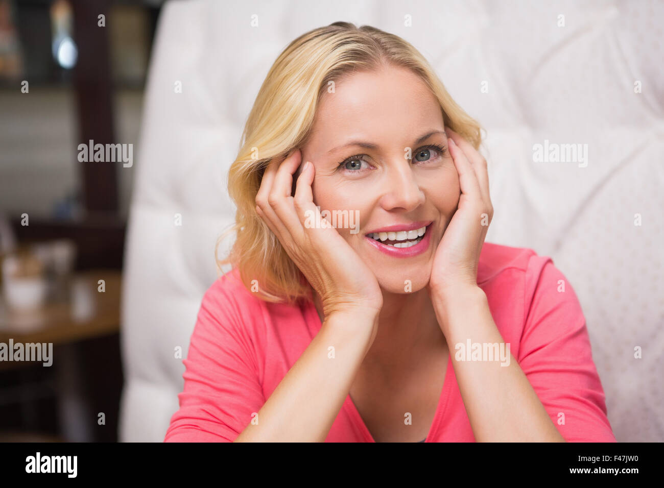 Pretty Blonde Sitting And Thinking Stock Photo Alamy
