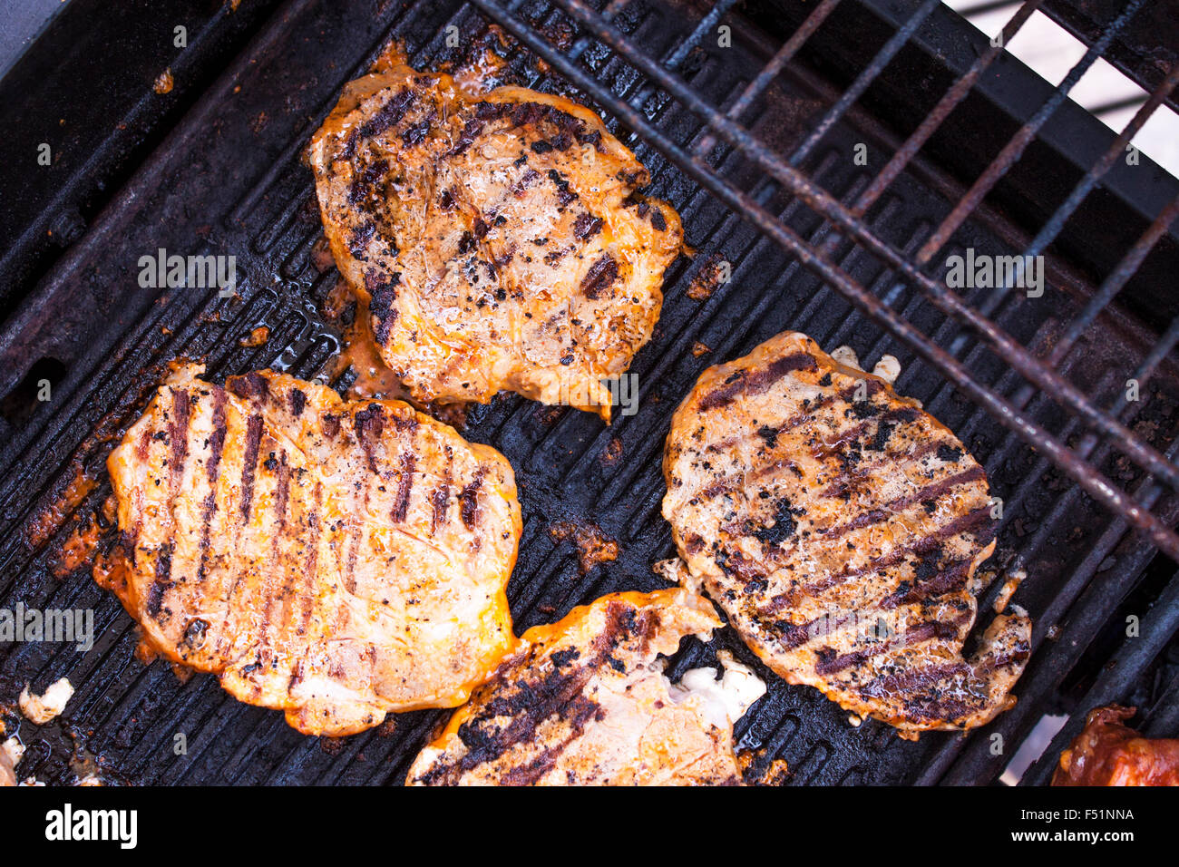 Brushed Marinated Pork Neck On A Gas Barbeque Stock Photo Alamy