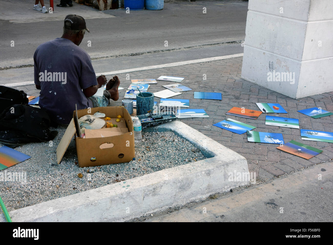 Street artist selling his paintings on the street near Straw market