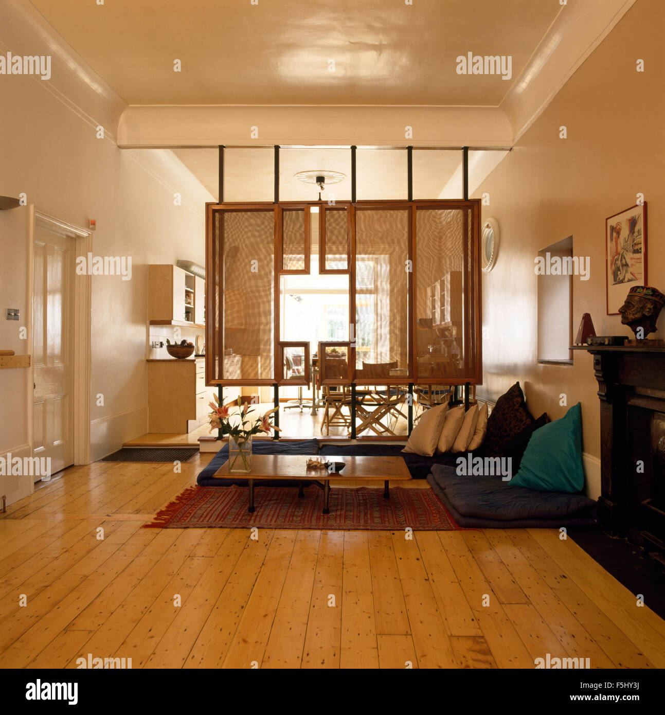 Studio Apartment Open Plan wooden flooring and rattan screen in seventies open plan studio Studio Apartment Open Plan wooden flooring and rattan screen in seventies open plan studio