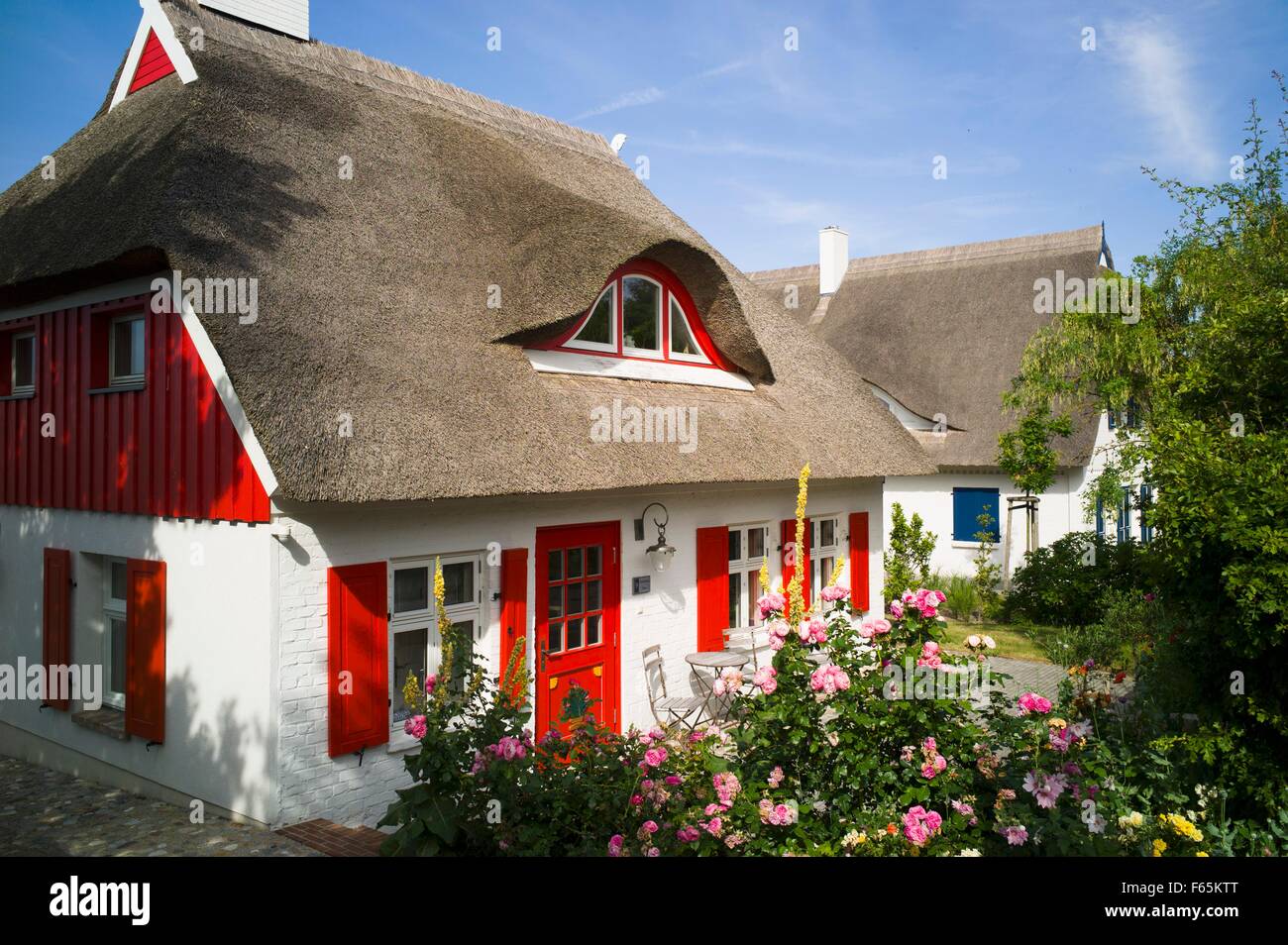 Red Door House a thatched roof house with a red door and shutters, ahrenshoop on Red Door House a thatched roof house with a red door and shutters, ahrenshoop on
