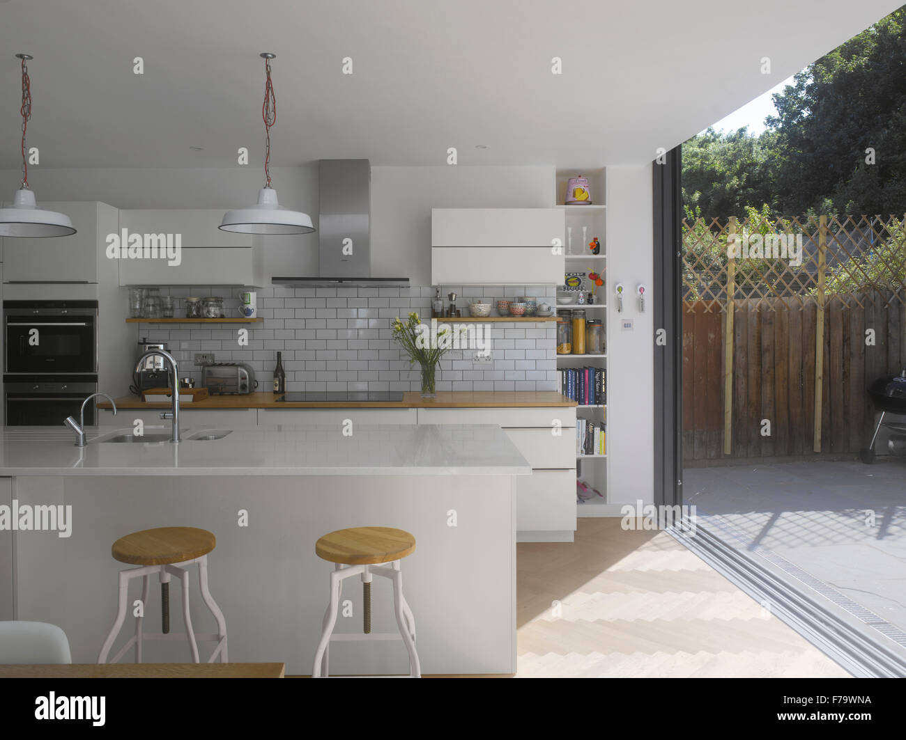 Kitchen And With Sliding Door To Garden In UK Home Stock Photo