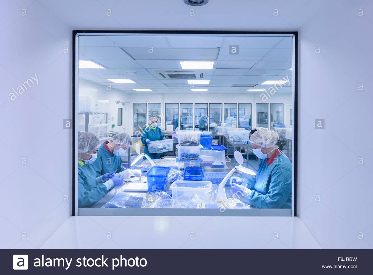 Workers inspecting surgical instruments in clean room of surgical Stock