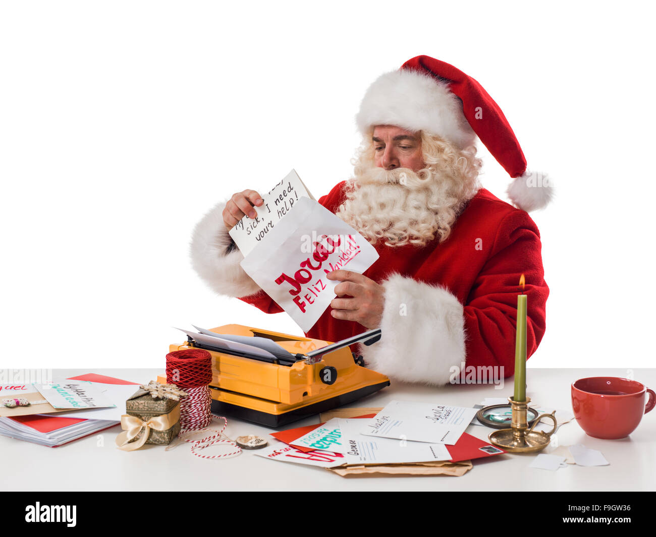 Santa Claus reading children letters and writing responses to them
