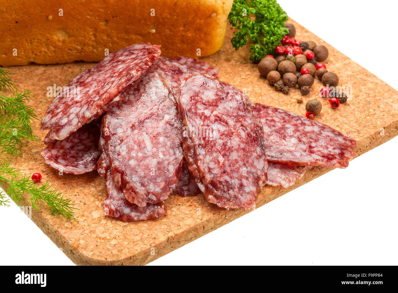 Fresh ripe salami with bread and vegetables Stock Photo, Royalty Free