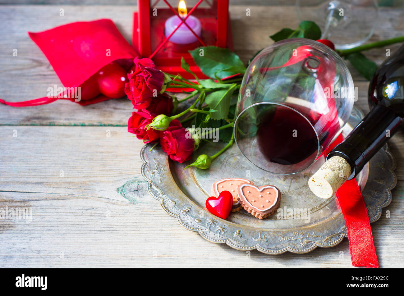 Table Setting For St Valentines Day With Glasses Of Red Wine Present Box And Roses In Rustic Style Table Setting For St Valentines Day With Glasses Of Red Wine Present Box And Roses In Rustic Style
