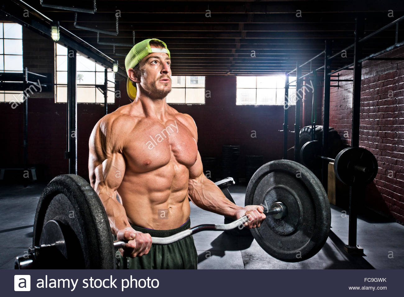 A crossfit athlete performs bicep curls Stock Photo, Royalty Free Image