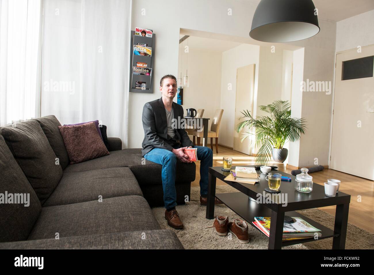 Regular Living Room tilburg, netherlands. young couple sitting in their living room Regular Living Room tilburg, netherlands. young couple sitting in their living room