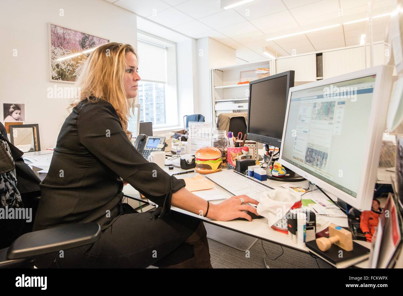 New York, USA. Consular employee at her office desk in the ...
