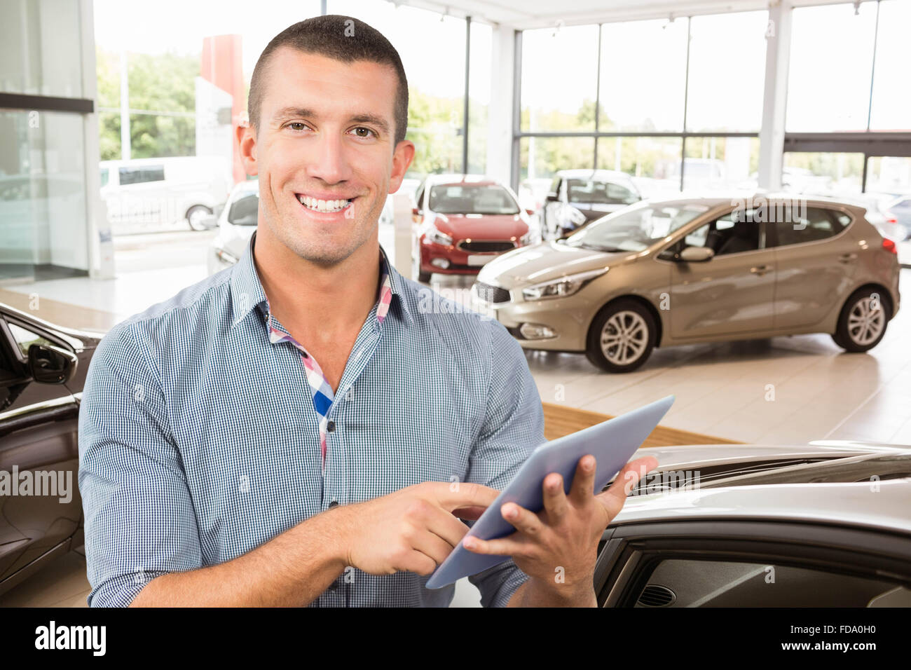 Composite Image Of Smiling Businessman Using Tablet Computer Over White