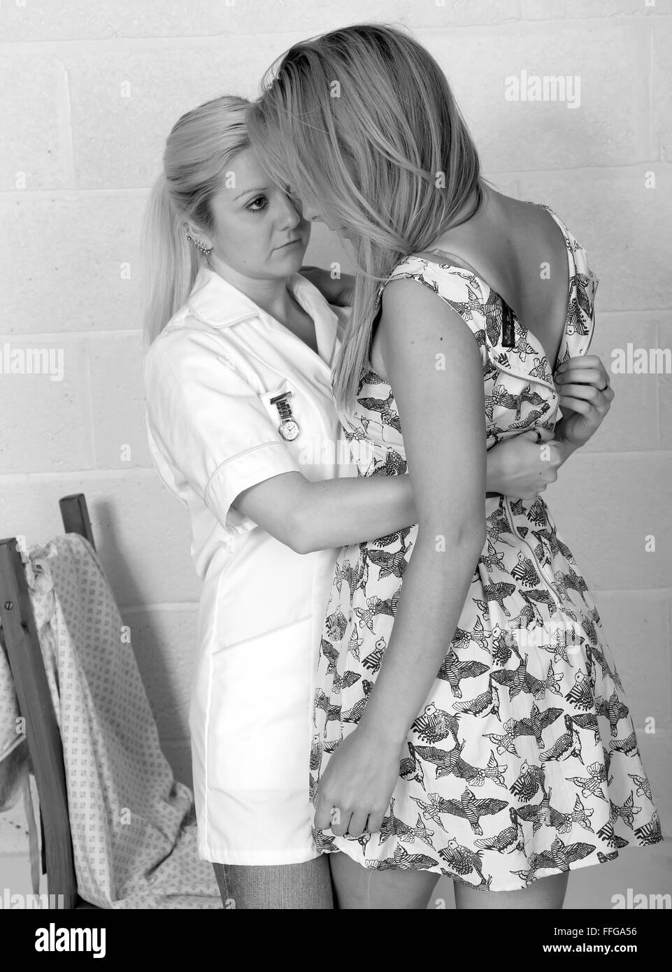 Young Nurse Assisting A Patient Undress And Chang