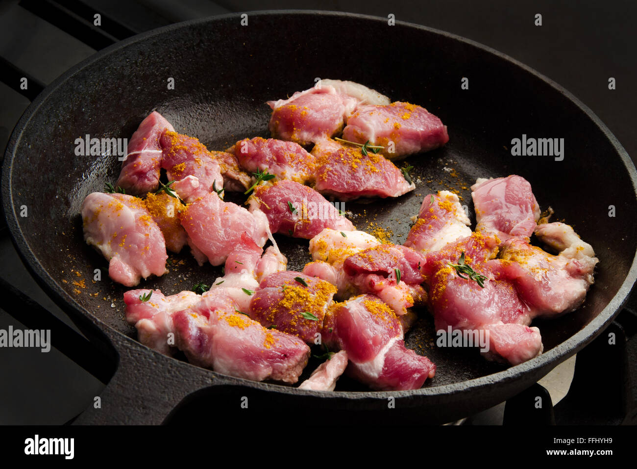 Cooking beef stew in a cast iron skillet on the cooker. Stock image