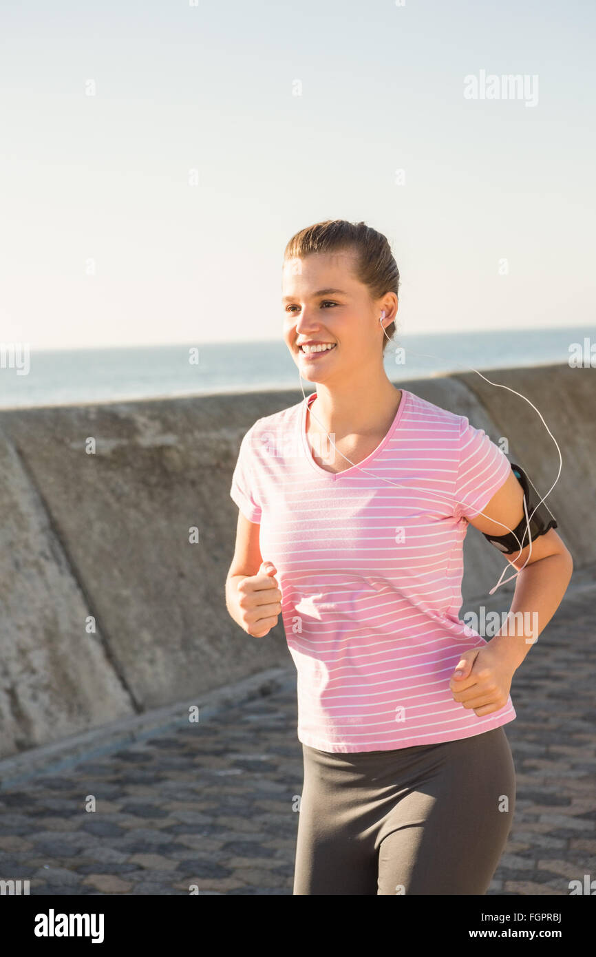 Smiling Sporty Blonde Jogging With Headphones Stock Photo Alamy