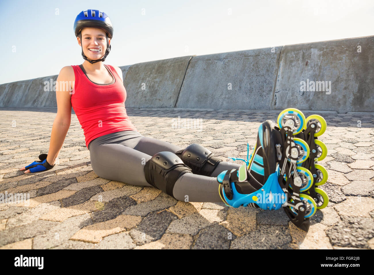 Smiling Sporty Blonde Skater Sitting On Ground Stock Photo Alamy