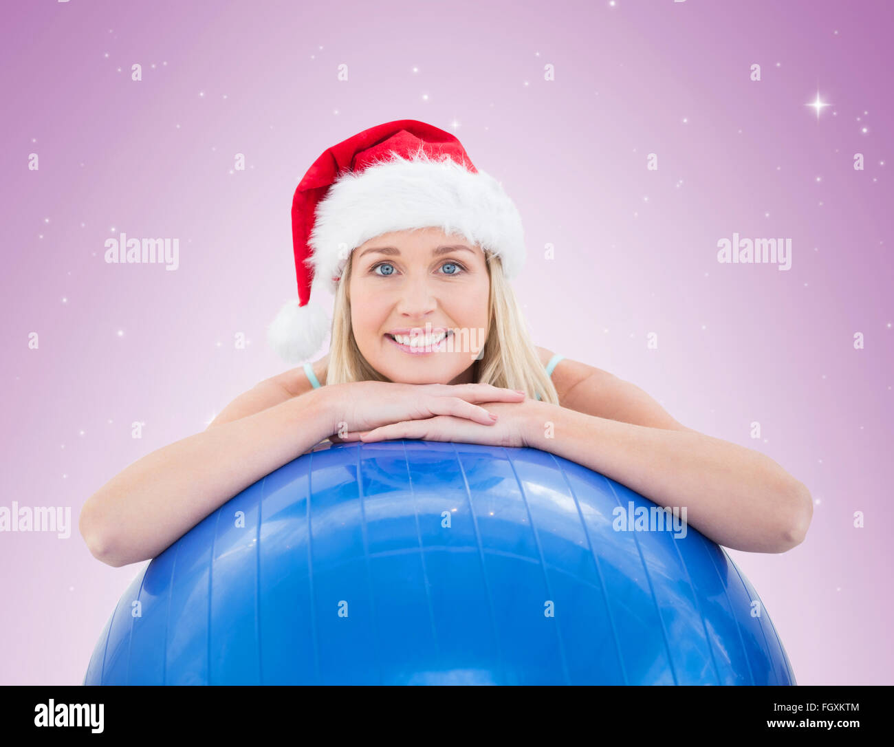 Festive Fit Blonde Leaning On Exercise Ball Stock Photo Alamy