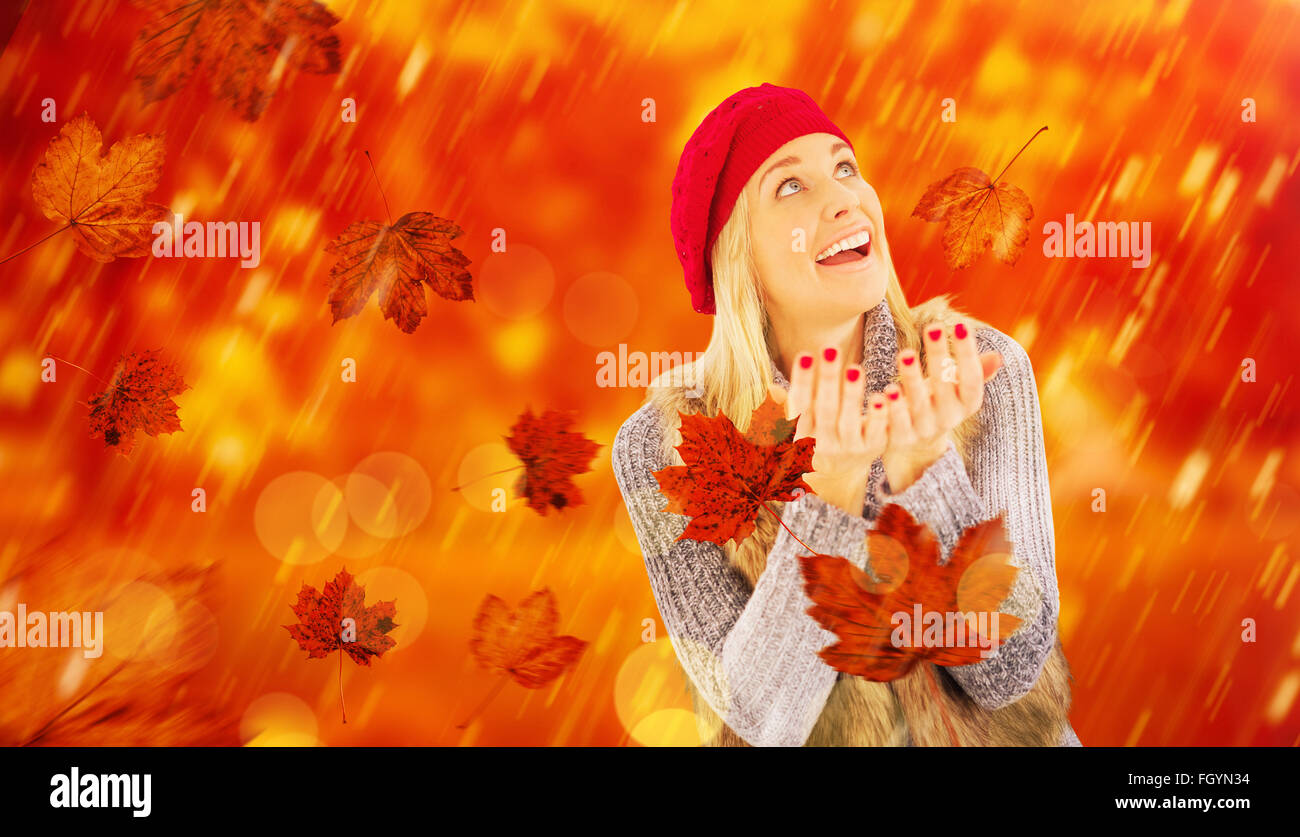 Composite Image Of Blonde In Winter Clothes With Hands Out Stock Photo