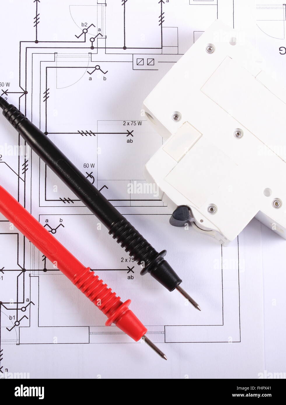 cables of multimeter and electric fuse lying on construction drawings of house electrical drawings and tools for engineer jobs cables of multimeter and electric fuse lying on construction drawings of house electrical drawings and tools for engineer jobs