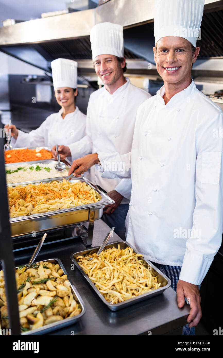Chefs standing at serving trays of pasta Stock Photo, Royalty Free