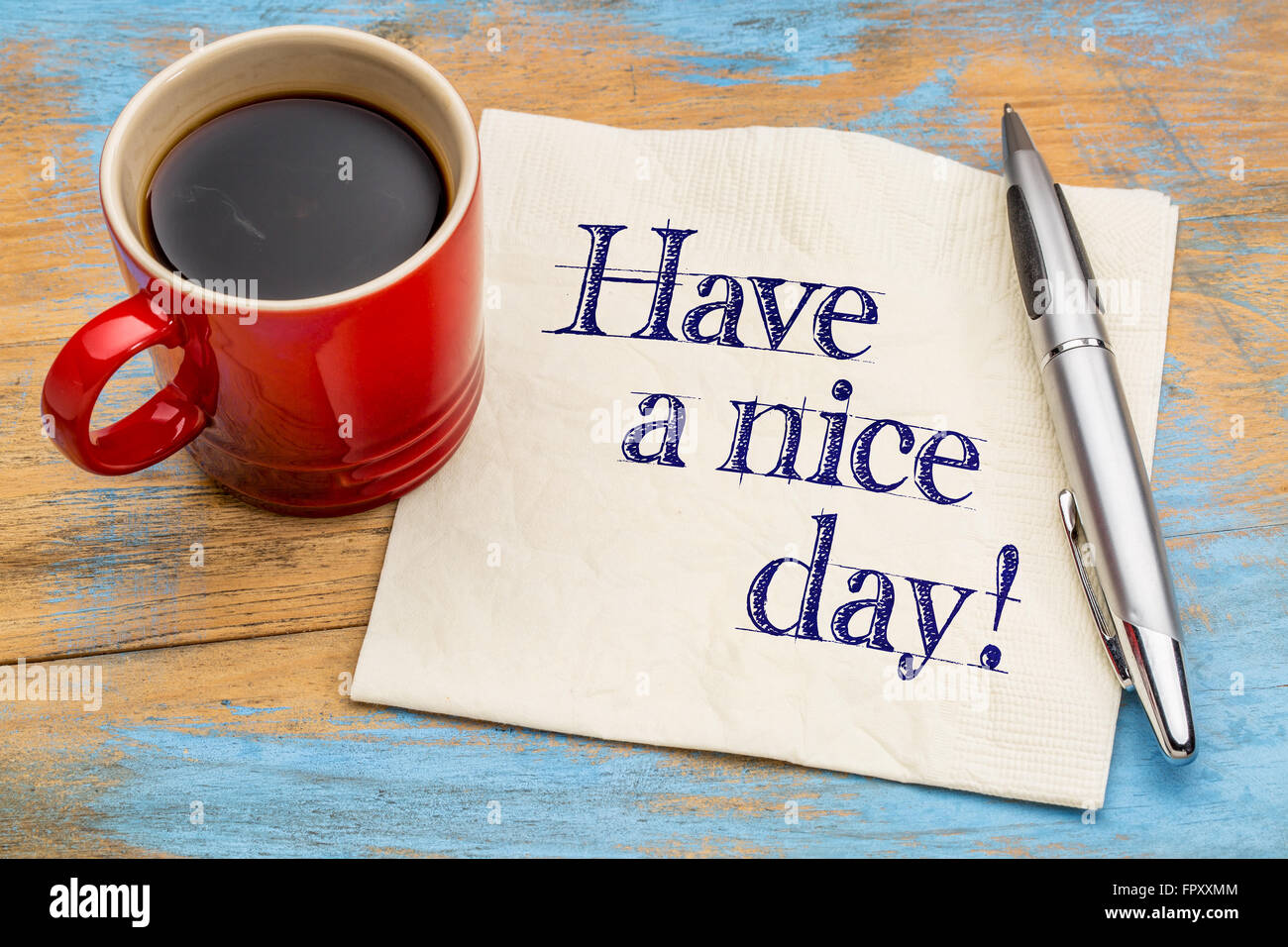 Have a nice day! Handwriting on a napkin with cup of ...