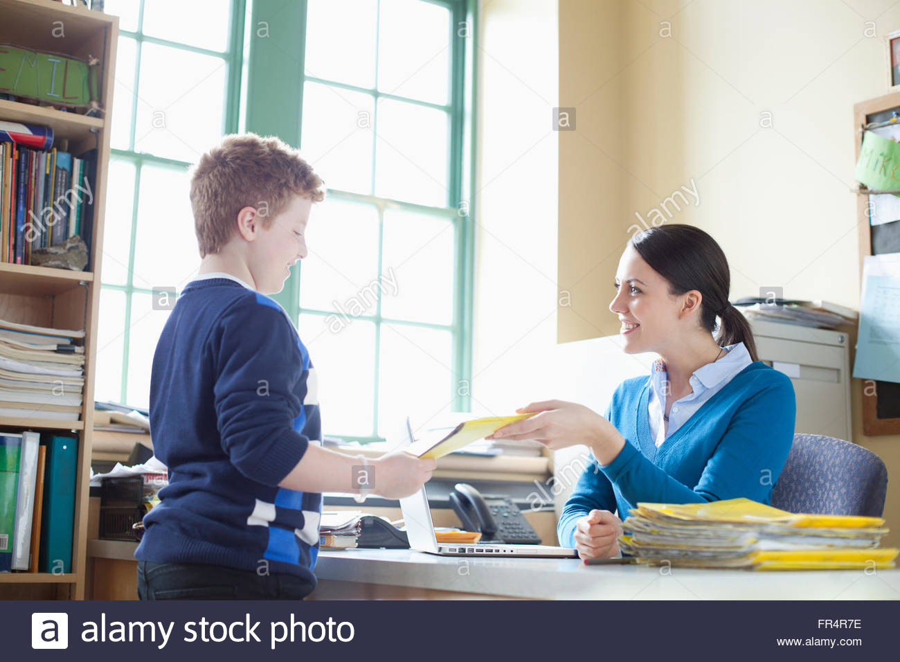 students-handing-in-homework-to-teacher-stock-photo-royalty-free-image
