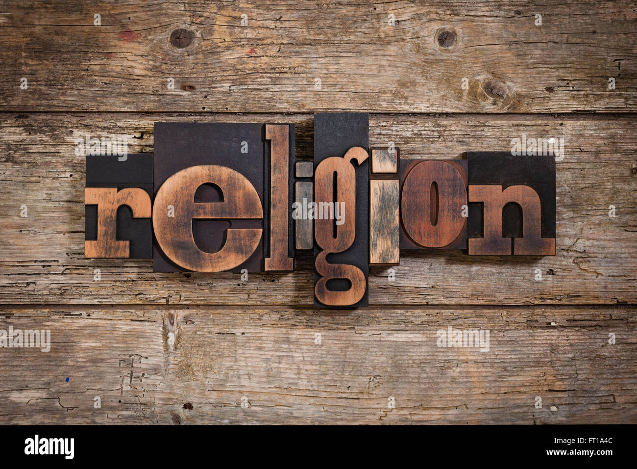 Religion Word Written With Vintage Letterpress Printing Blocks On Rustic Wooden Background Religion Word Written With Vintage Letterpress Printing Blocks On Rustic Wooden Background