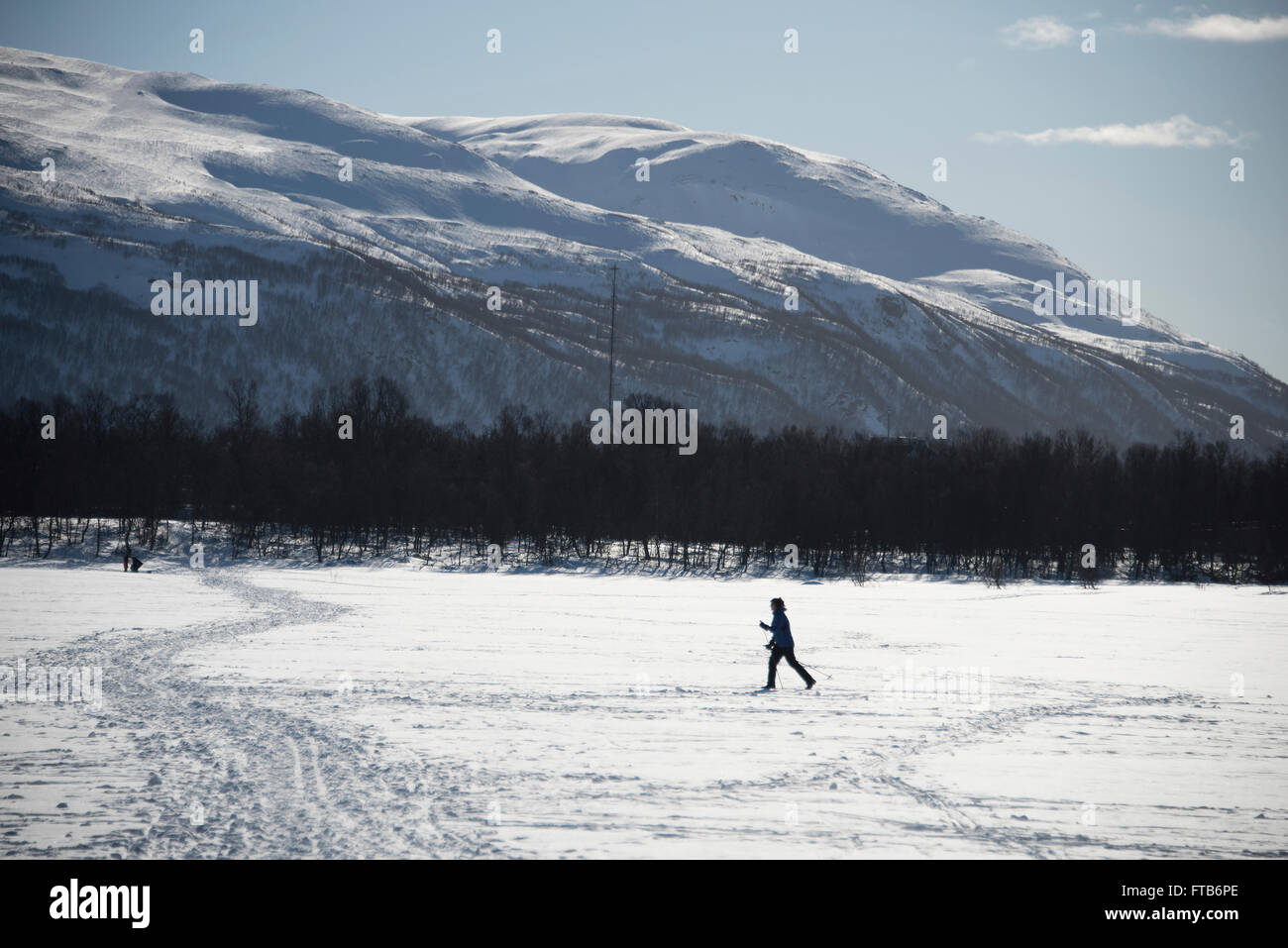 Cross country skiing across a frozen lake in Tromso, Norway Stock Photo