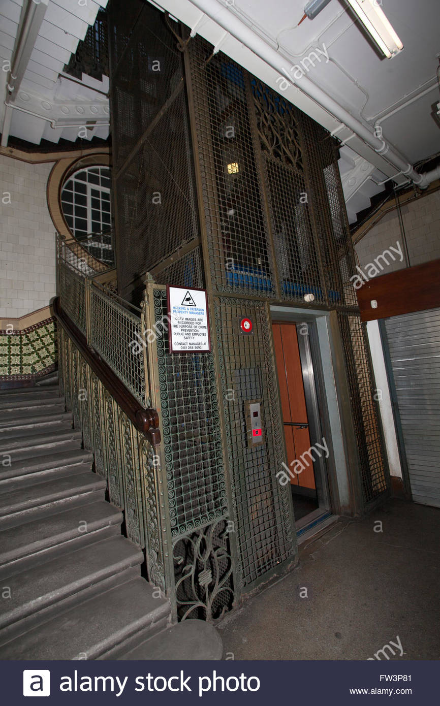 Beautiful building, old wrought iron cage elevator with door open on