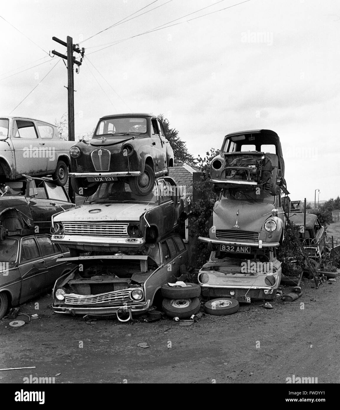 Old car cars piled high scrapyard Britain 1975 Stock Photo 101725541