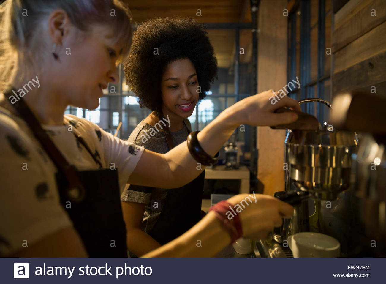 Baristas using espresso machine in coffee shop Stock Photo, Royalty