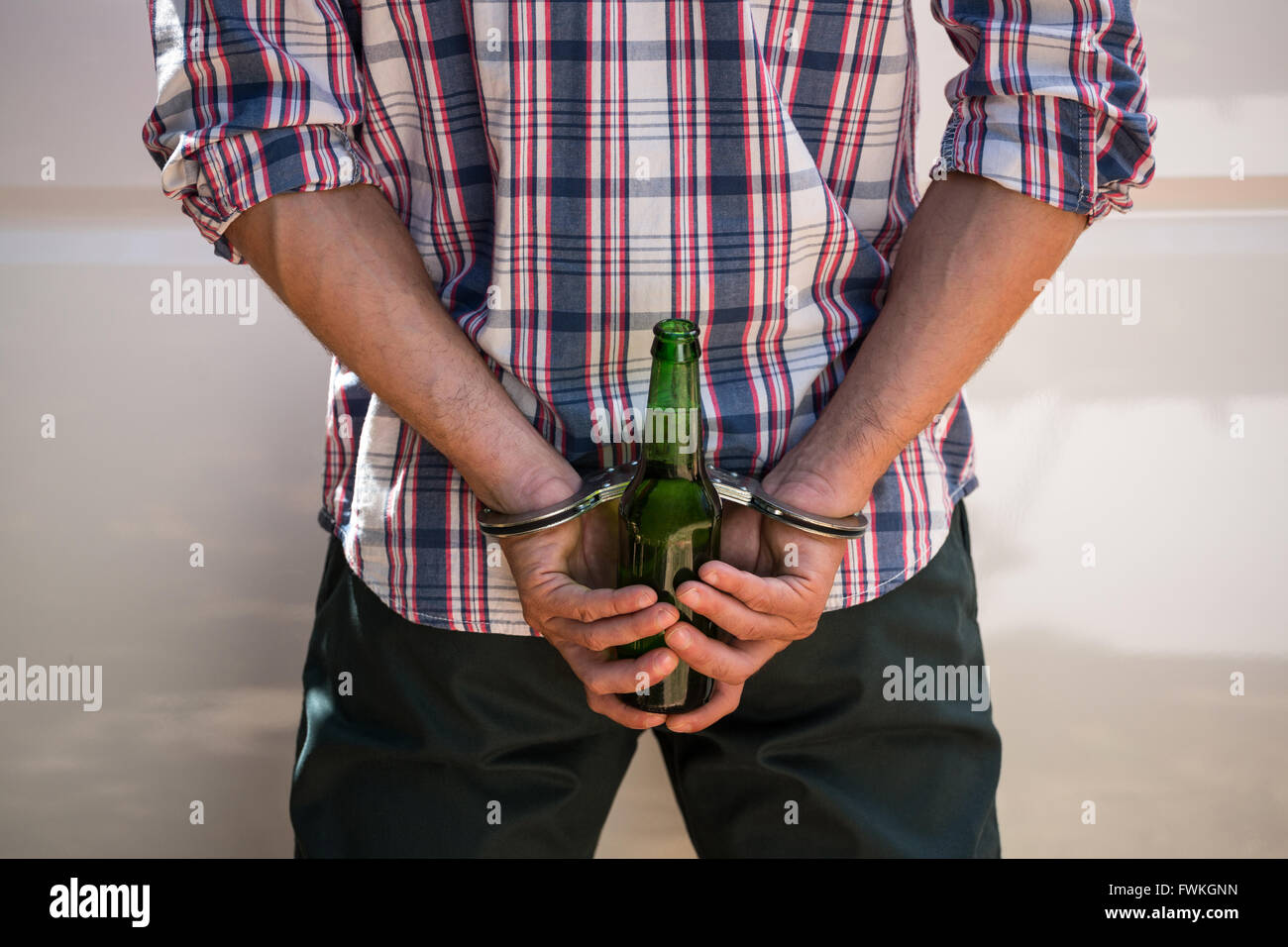 Man handcuffed behind his back Stock Photo, Royalty Free Image