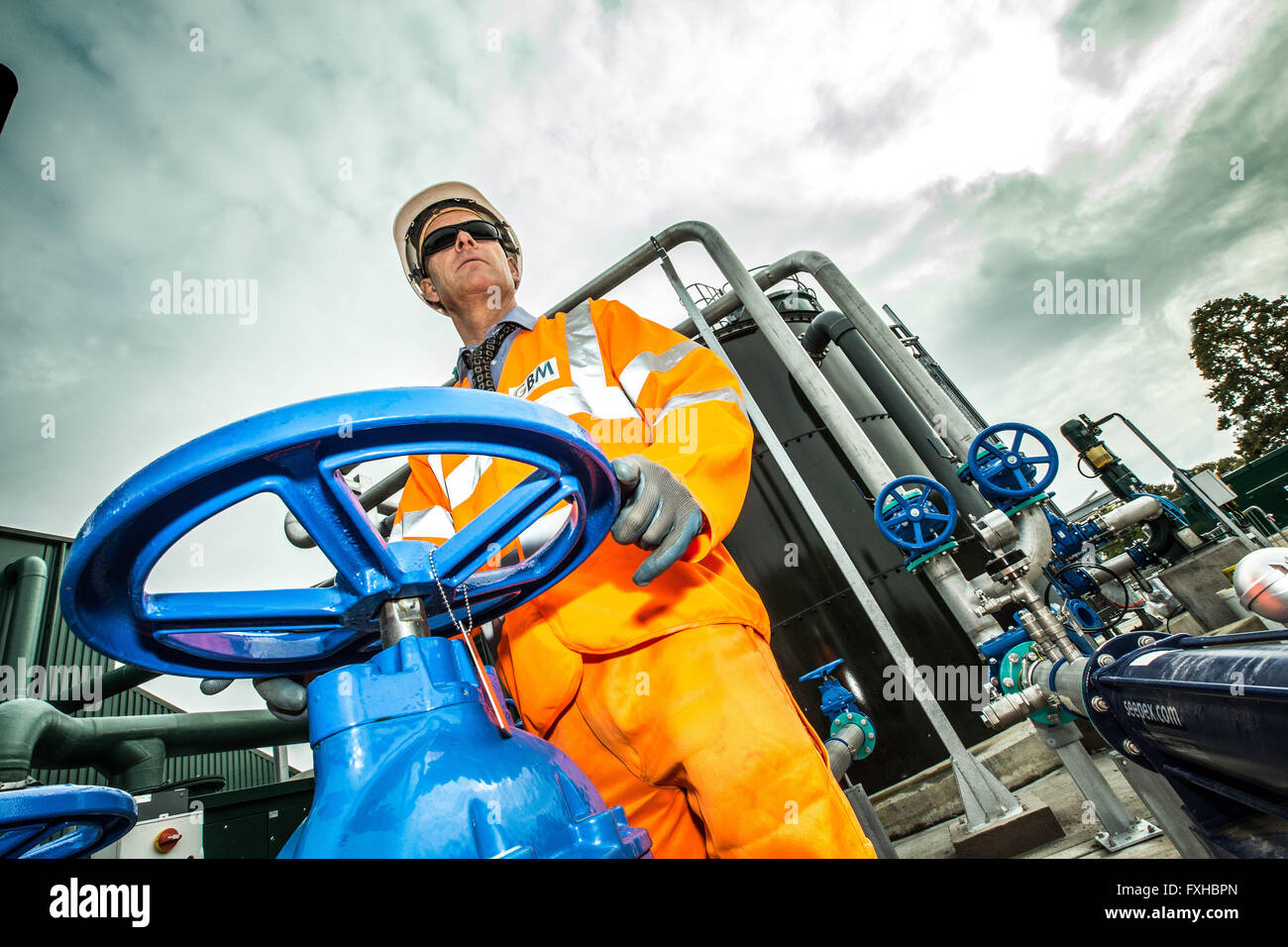 Water worker on site in waste water treatment works Stock Photo