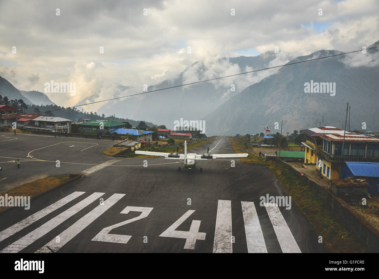 Take off from the short runway at Lukla Airport near mt Everest Stock