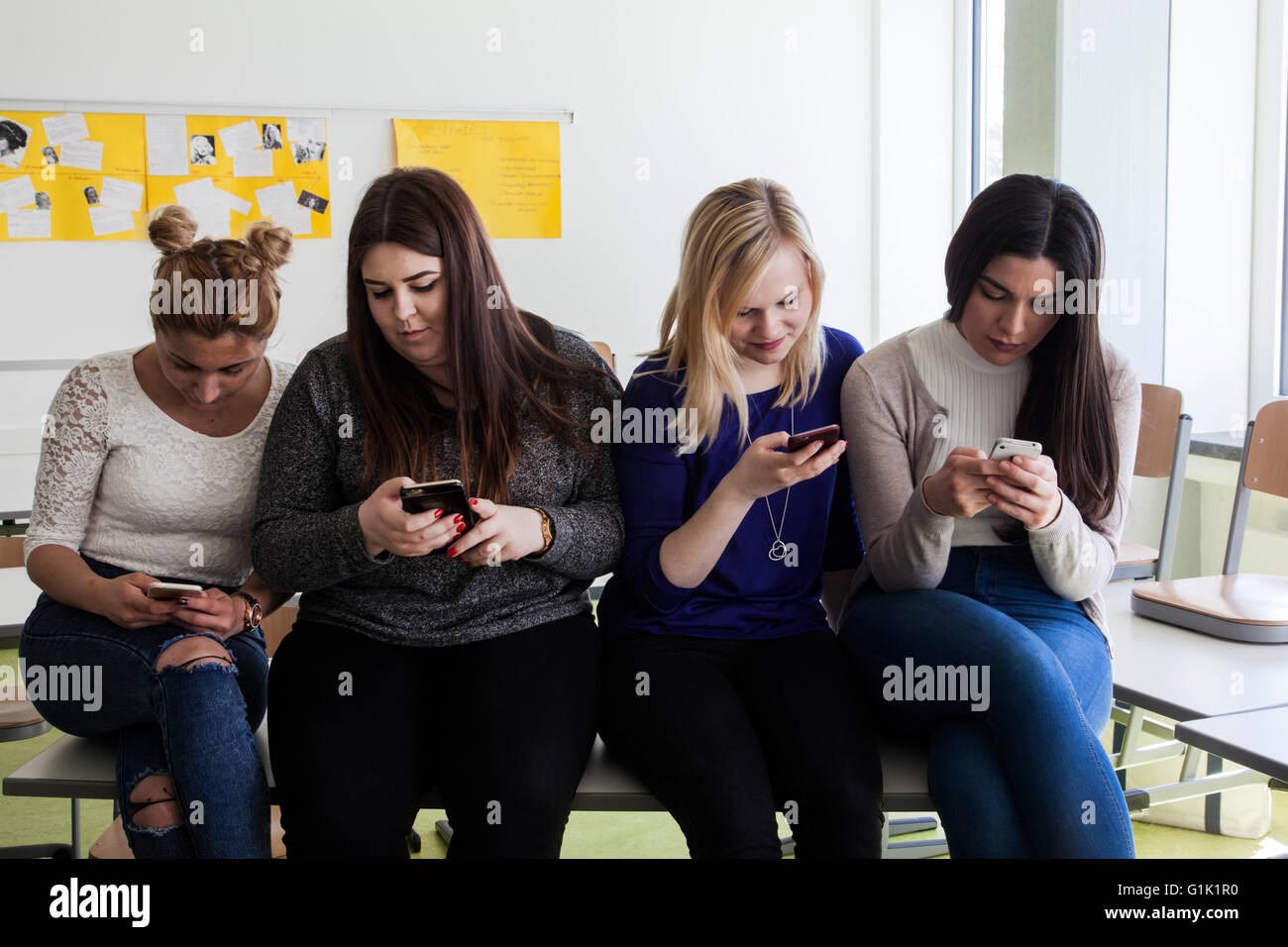 The headdown generation is on working with their smartphone Stock