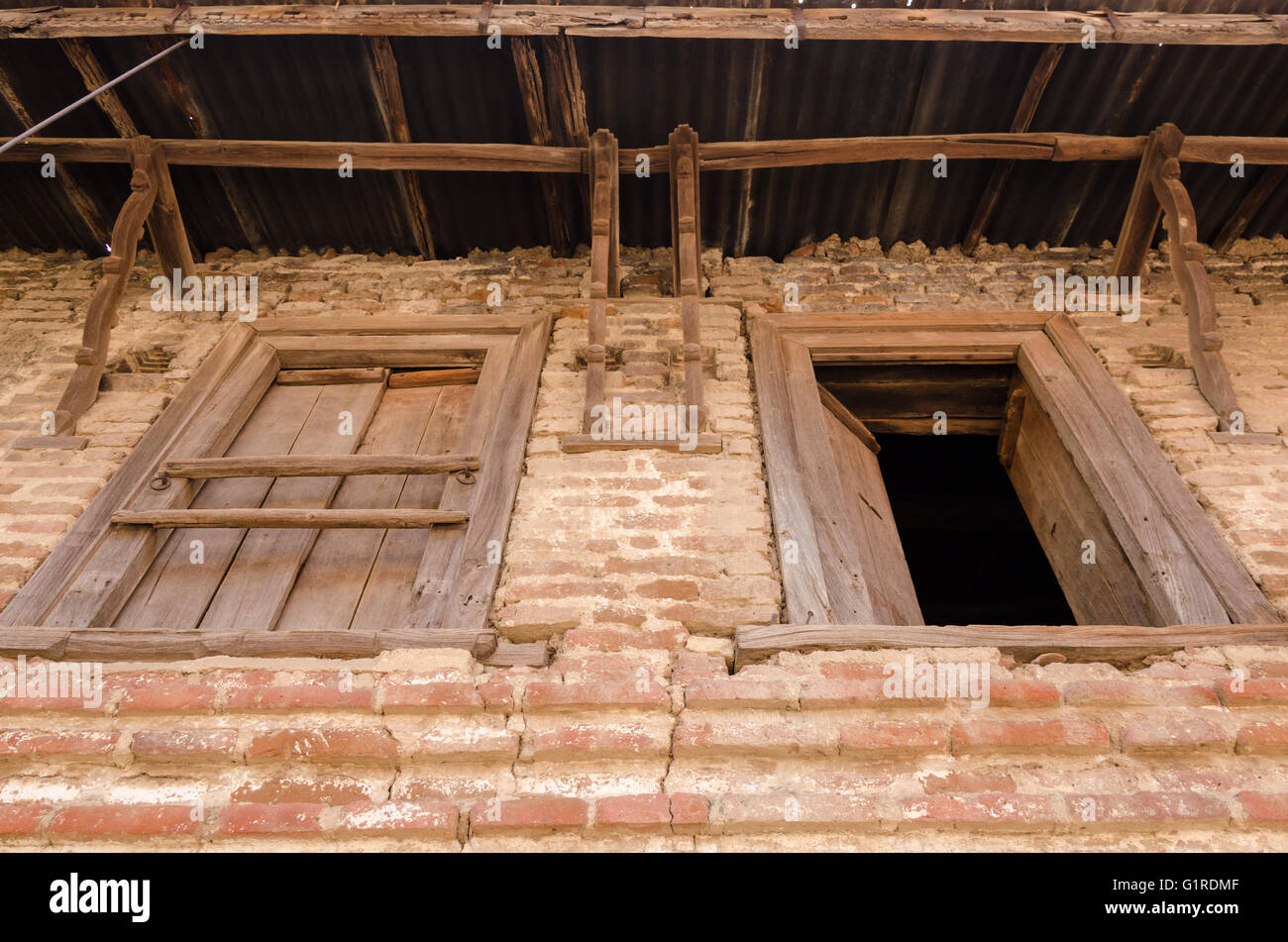 Stock photo wooden windows on stone brick wall of a village house in gujarat india