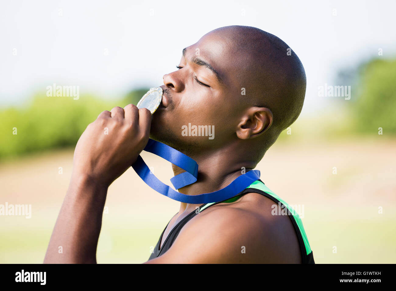 Athlete Kissing His Gold Medal Stock Photo Alamy