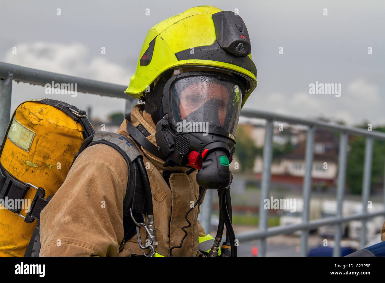 Female Firefighter wearing breathing apparatus on a gantry access Stock