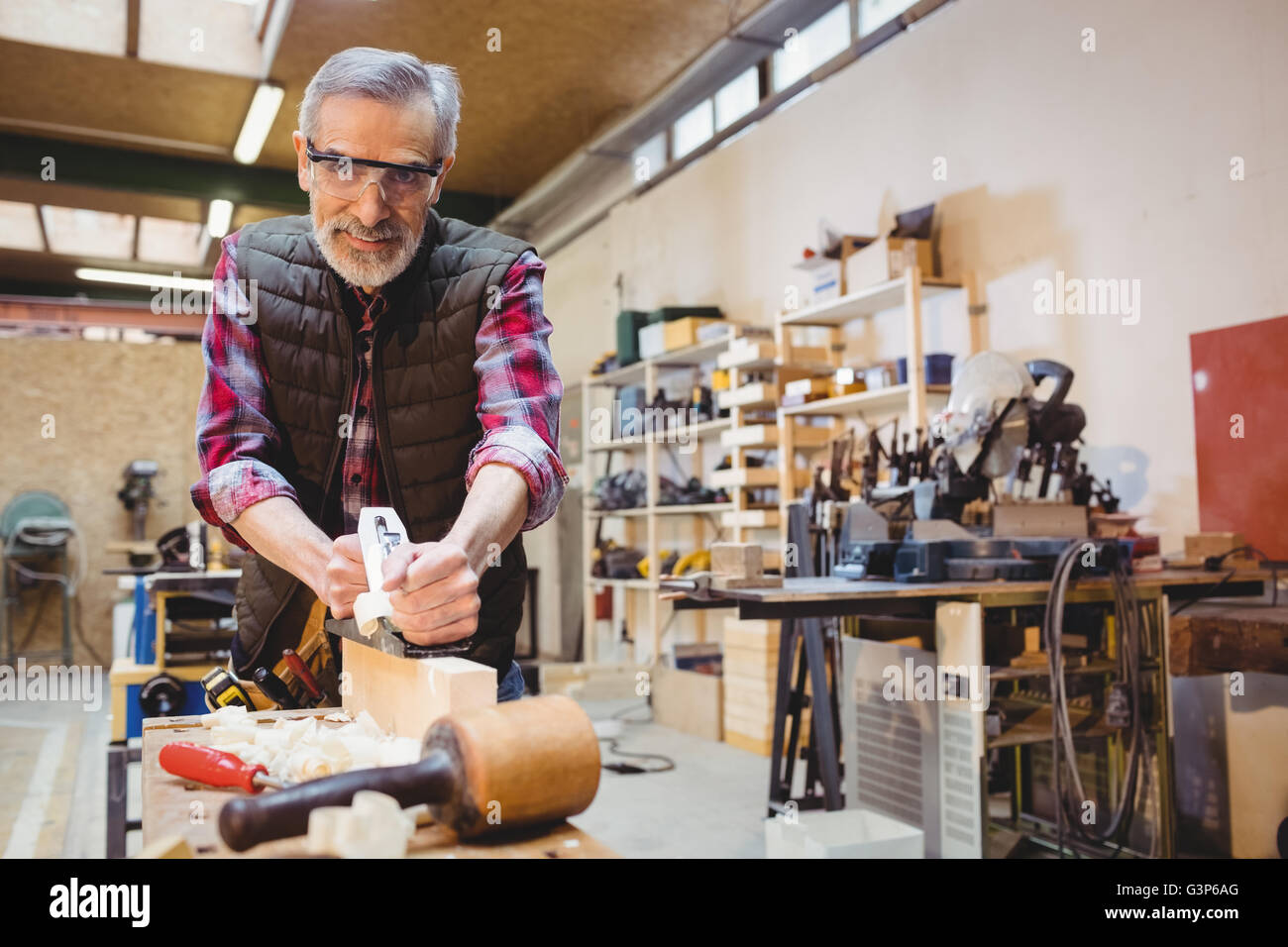 Carpenter Using A Sander To Make Smoother A Wood Plank Stock Photo Alamy