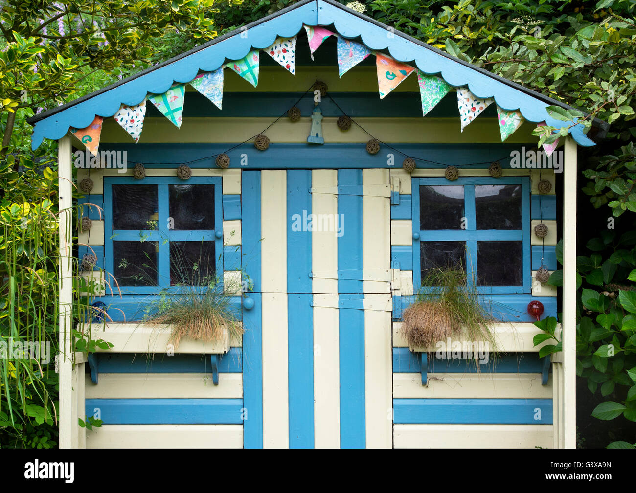 Striped blue and cream painted summer house in a cottage ...