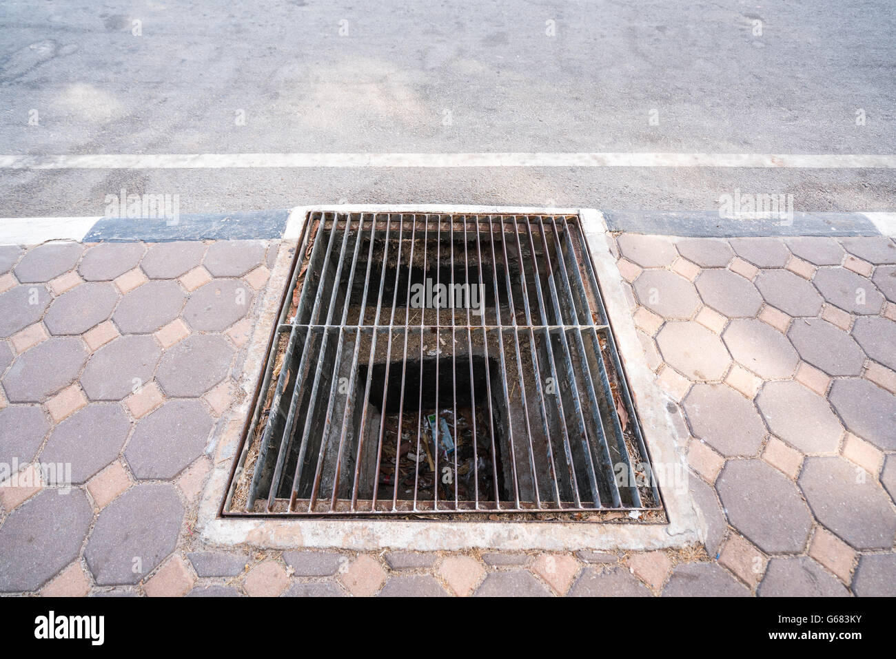 Stained steel grill sewer cover or sewage drain cover, on public Stock