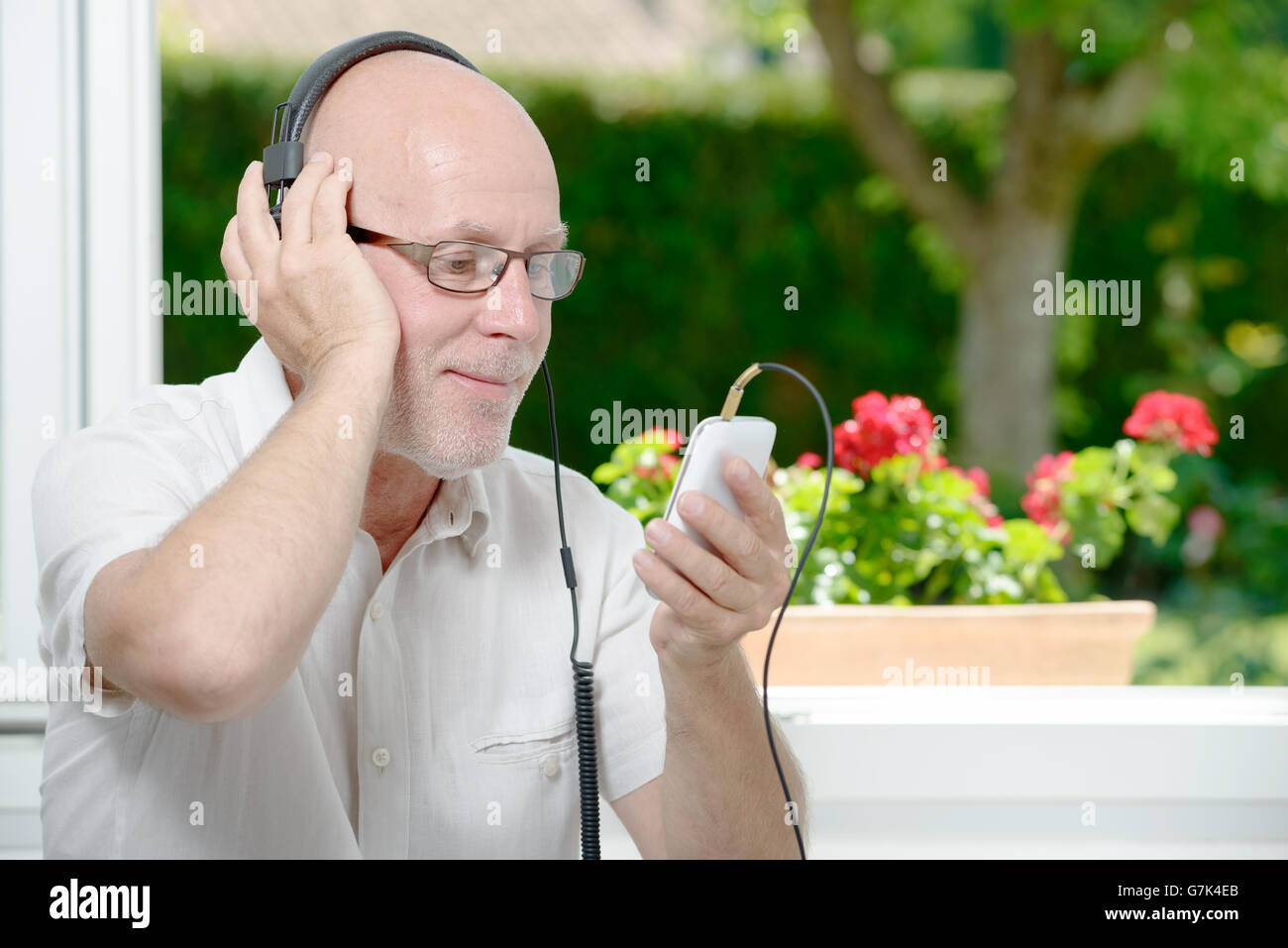 A Mature Man Listening To Music With Headphones Stock Photo Alamy