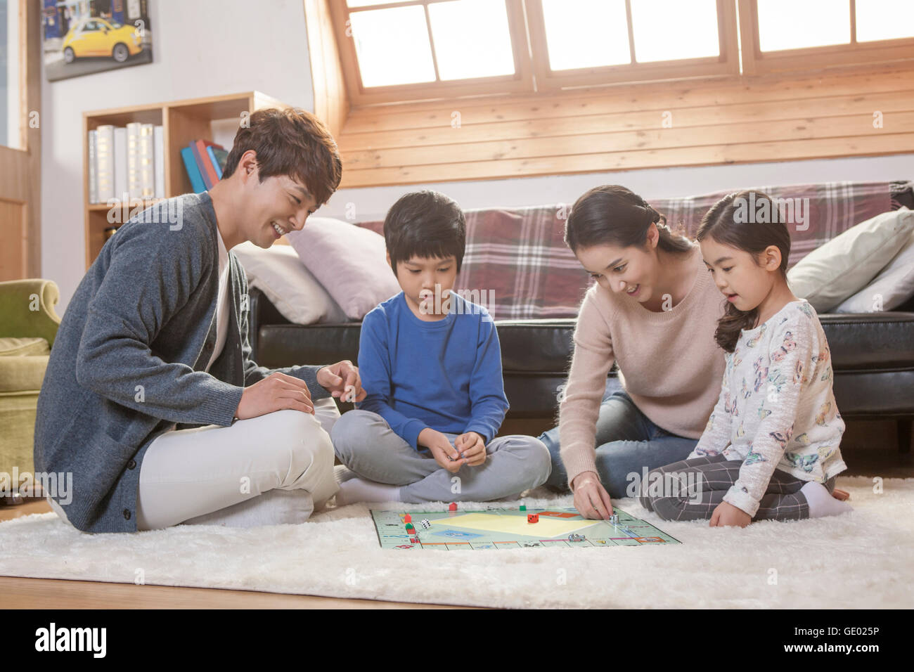 Harmonious Family Playing A Board Game Together In Living Room Harmonious Family Playing A Board Game Together In Living Room