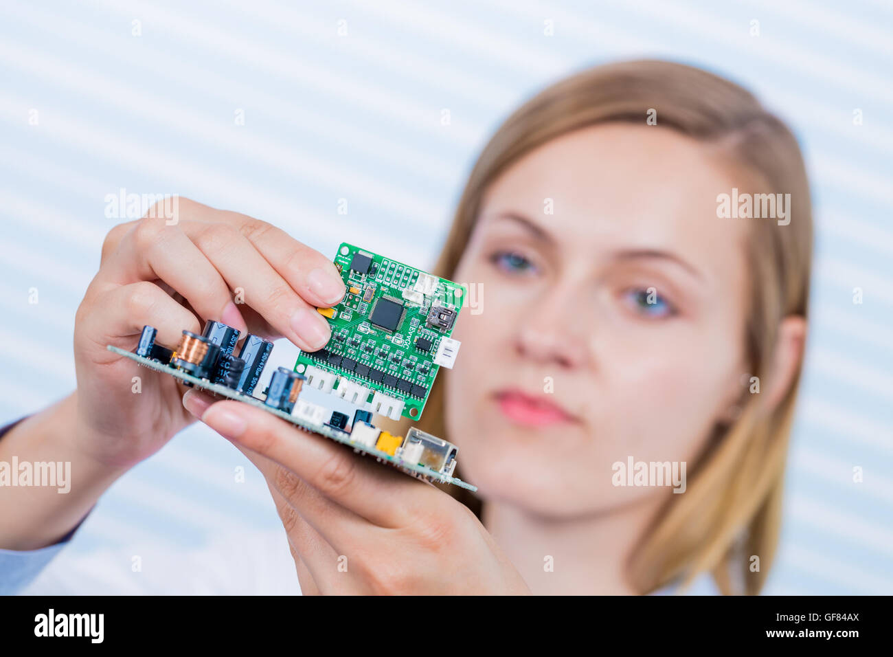 Tech tests electronic equipment in service centre Stock Photo, Royalty