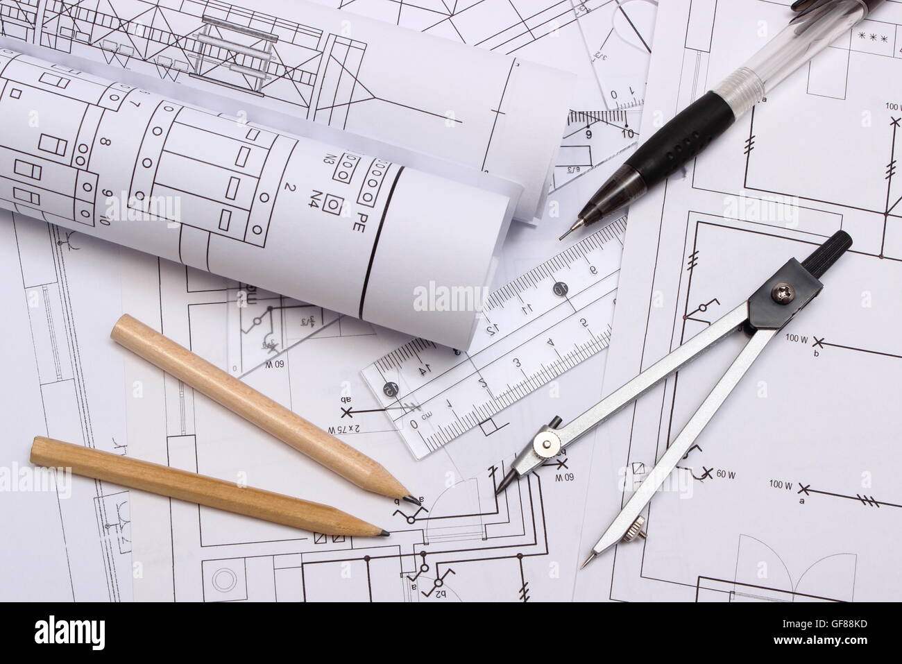 rolls of electrical diagrams and accessories for drawing lying on construction drawing of house drawings rolls of electrical diagrams and accessories for drawing lying on construction drawing of house drawings