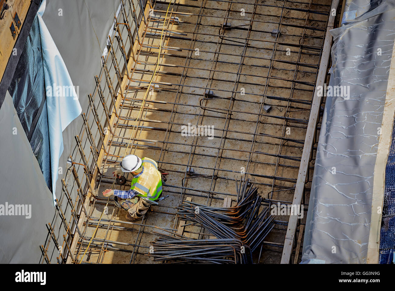 Construction Worker Laying Rebar And Wire For Concrete Basement