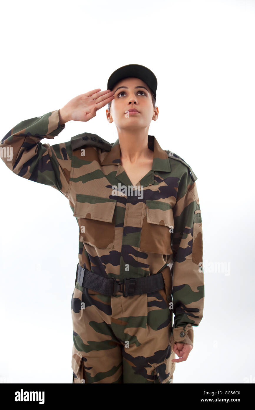 Female Soldier Saluting Looking Up Against White Background Female Soldier Saluting Looking Up Against White Background