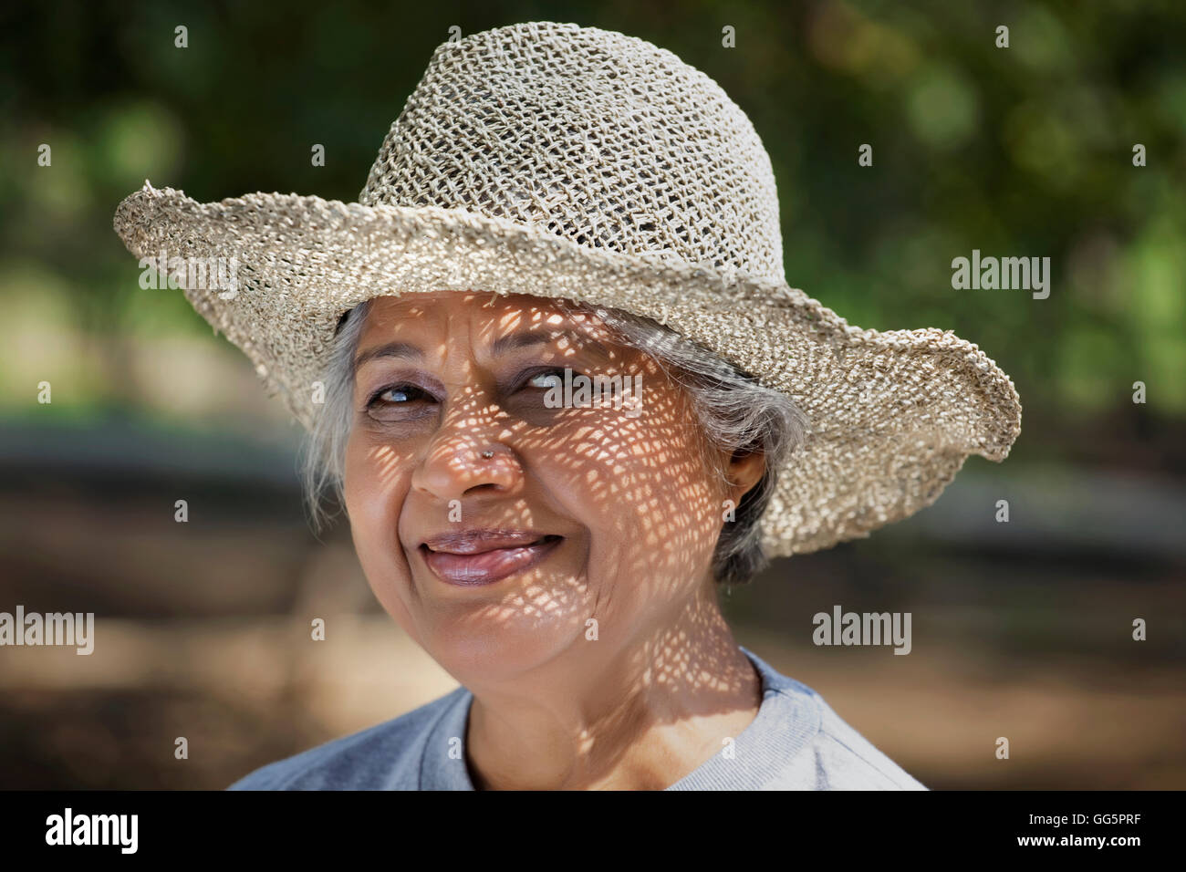 Portrait Of Smiling Mature Woman Wearing Hat At Park Stock Photo Alamy