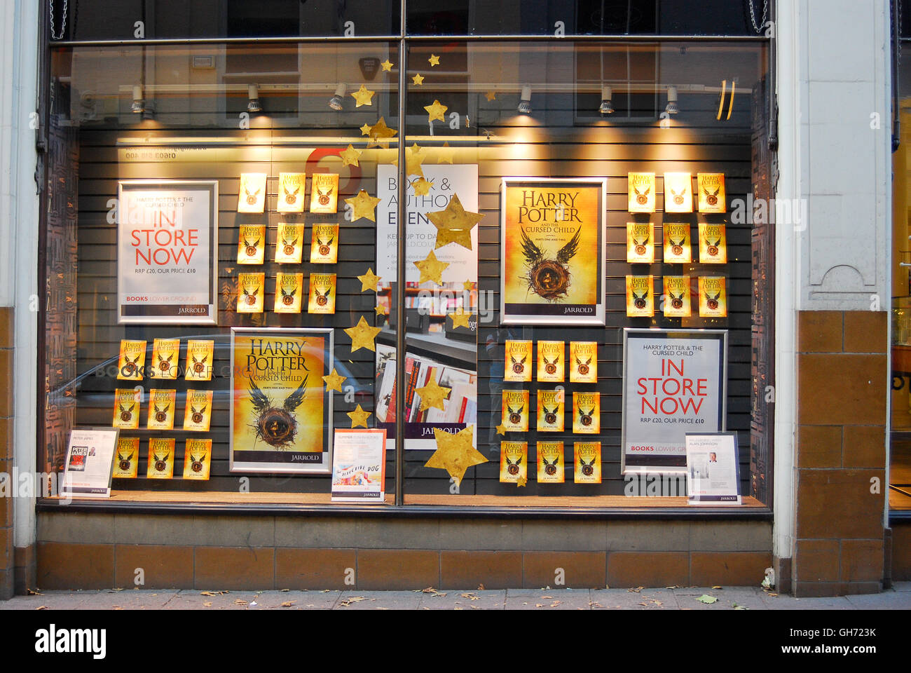 A bookstore window displays advertising for the latest book in the