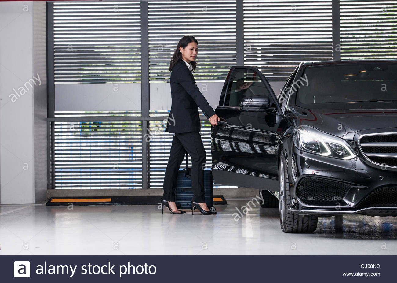 Businesswoman opening car door Stock Photo, Royalty Free Image