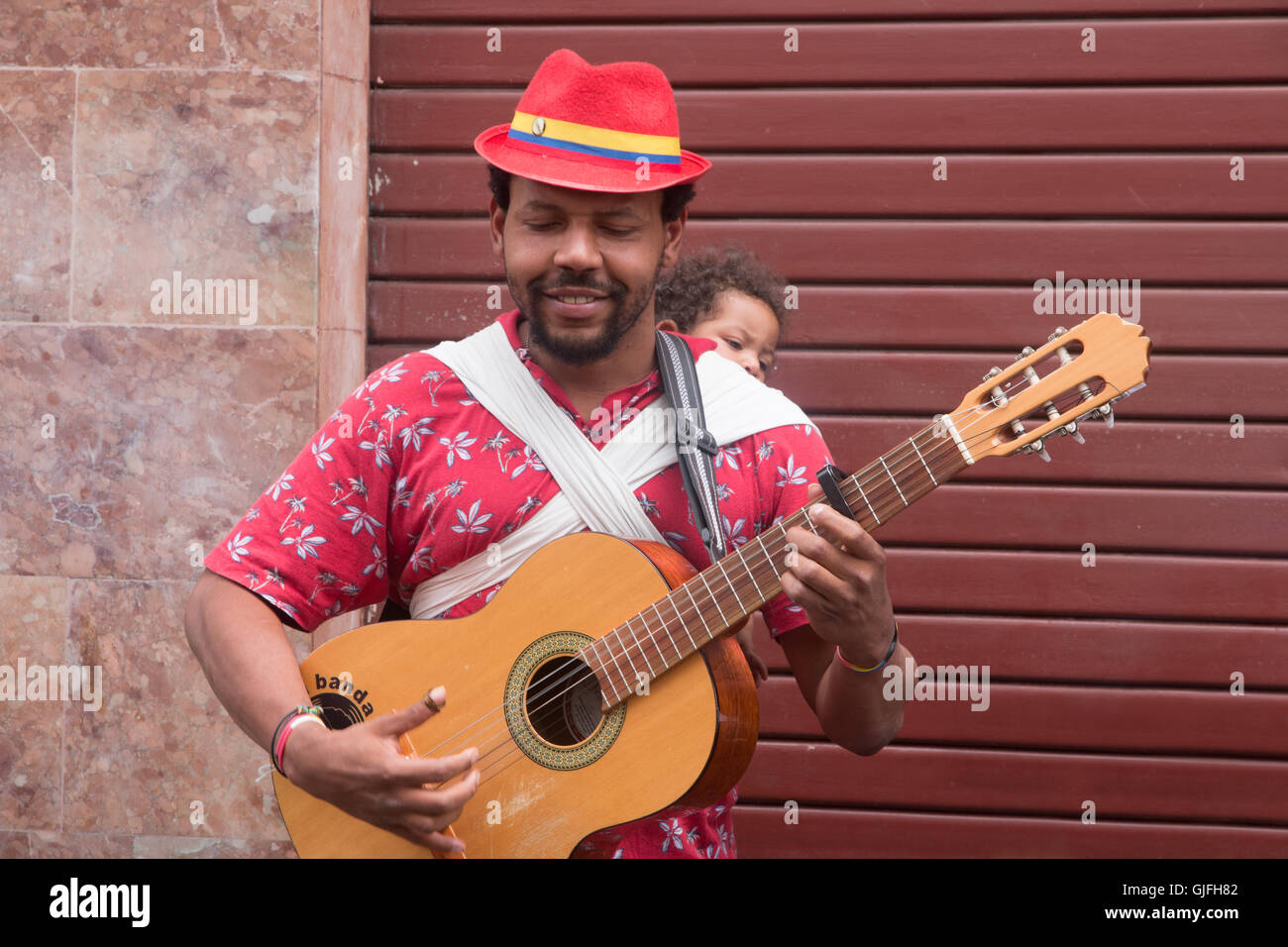 A street musician with child playing music in Quito, Ecuador Stock