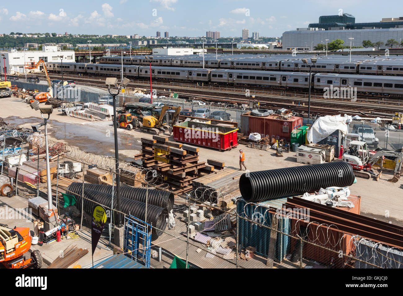 A construction staging area sits adjacent to the tracks in support of